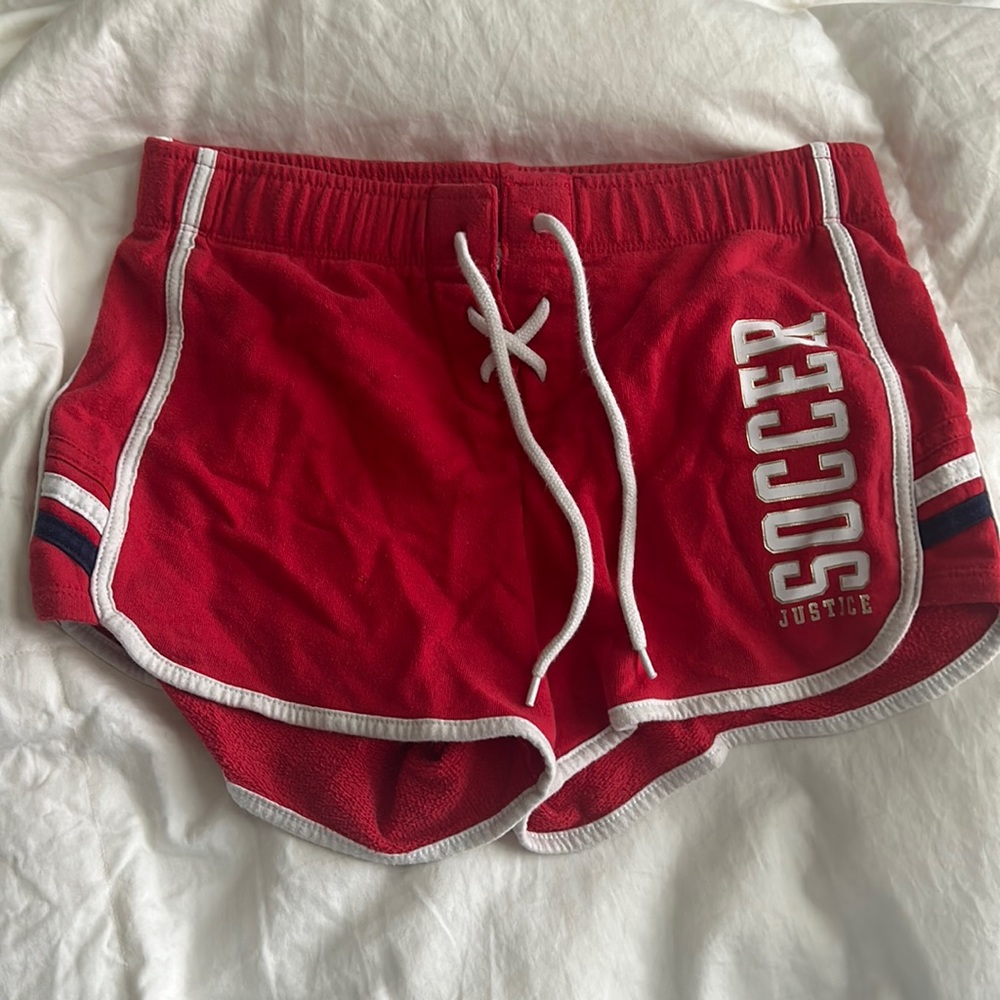 red athletic shorts from justice that say soccer